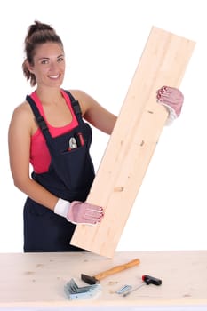 woman carpenter holding wooden plank on white background 