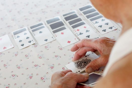 Senior playing solitaire