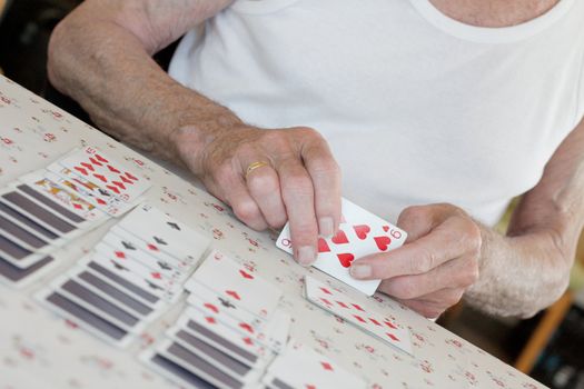 Senior playing solitaire