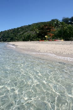 Exotic scene with kayaks on the beach