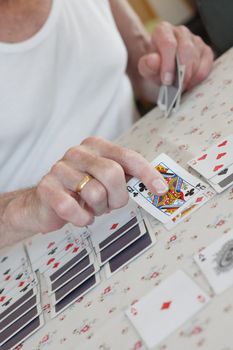 Senior playing solitaire