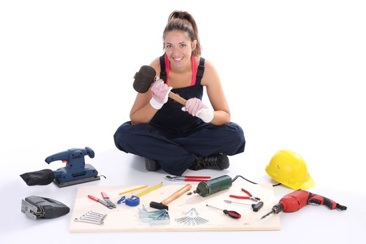 woman carpenter with work tools on wooden plank