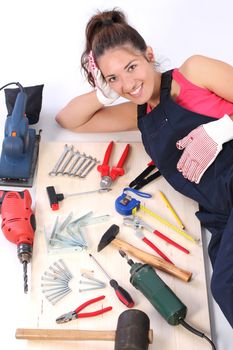 woman carpenter with work tools on wooden plank
