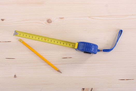 closeup shot of wooden plank and measuring tape 