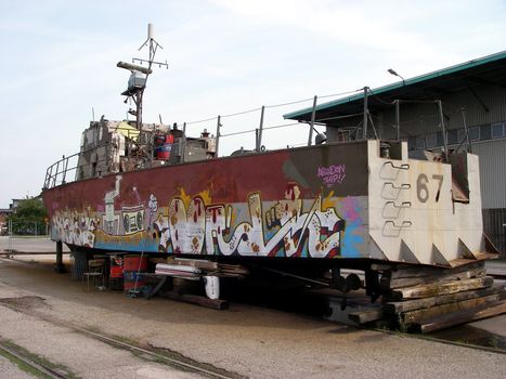 Graffiti on an old military ship in harbour
