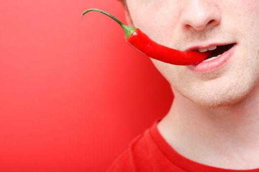 A man eating chili pepper