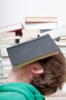 A man sleeping behind a book