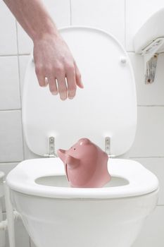 Throwing the piggy bank out in the toilet