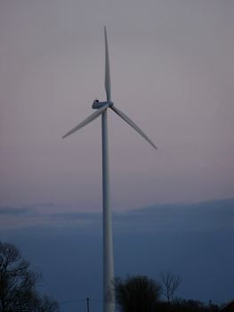 portrait of wind turbine in blue sky