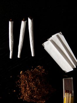 Portrait of handrolled joints on black