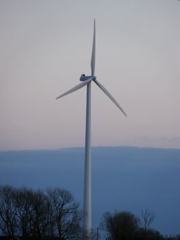 portrait of wind turbine in blue sky