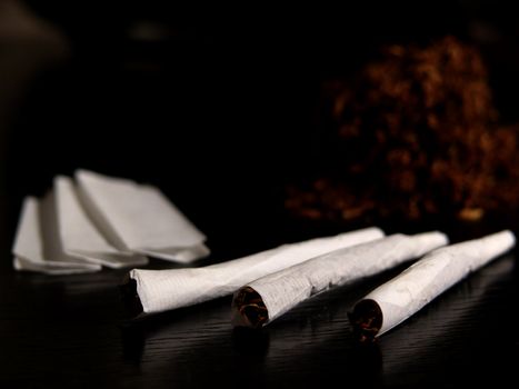 Portrait of handrolled joints on black