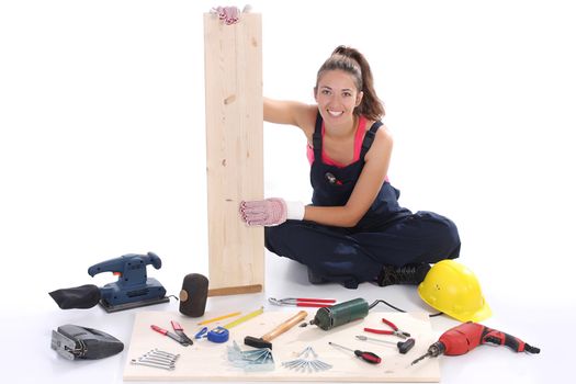 woman carpenter with work tools on wooden plank