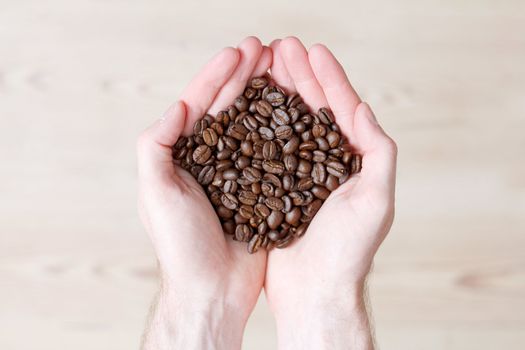 Hands holding coffe beans