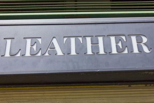 Image of leather sign in front of a leather goods shop.