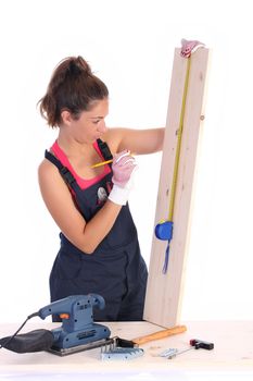 woman carpenter with wooden plank and measuring tape