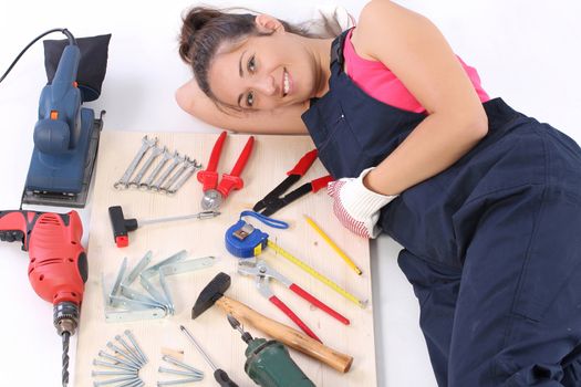 woman carpenter with work tools on wooden plank