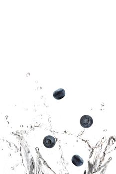 Blueberries splashing in water