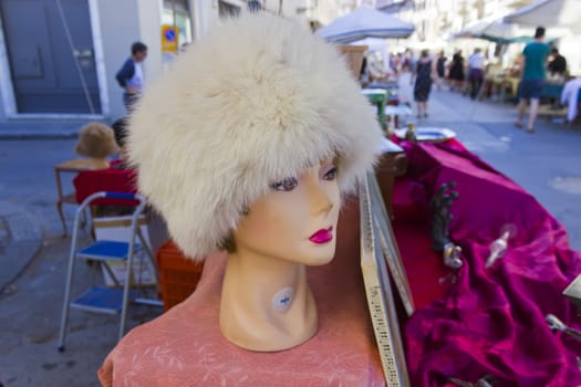 Vintage mannequin with fur hat at flea market.