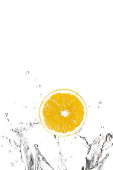 Oranges splashing in water