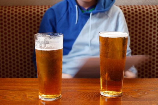 Two pints on a table in a pub