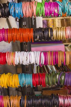 Image of a street vendor's stand selling leather wristbands.
