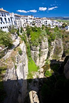 Panoramic view from a new bridge in Ronda, one of the famous white villages in Andalusia, Spain
