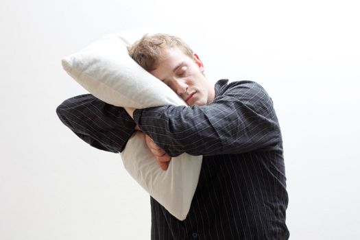 A man sleep walking with his pillow