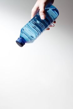 Hand holding a water bottle