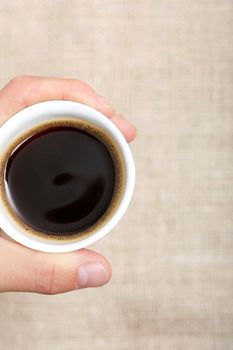 Hand holding a delicious cup of coffee