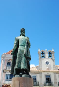 local statue of D.Pedro and typical church behind in Cascais, Portugal