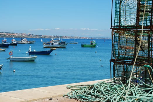 old fishing equipment with harbor background boats in Cascais, Portugal