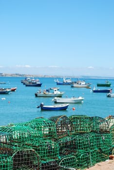 old fishing equipment with harbor background boats in Cascais, Portugal