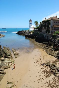 photo of a beach and lighthouse in Cascais, Portugal