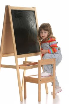 beauty a little girl climbing on a chair