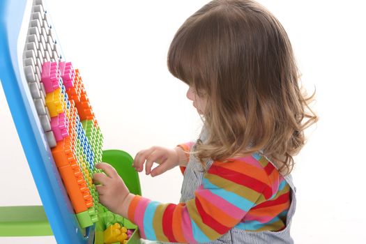 beauty a little girl playing colorful building toy blocks 