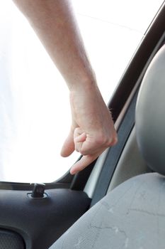 A hand unlocking a car door