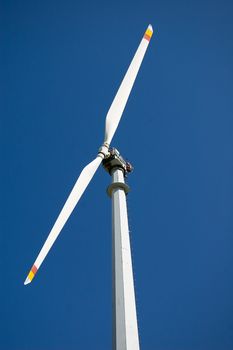 An high mountain wind turbine with blue sky background