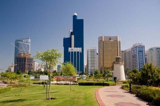 View of Abu Dhabi Skyline with gardens and small lighthouse in foreground