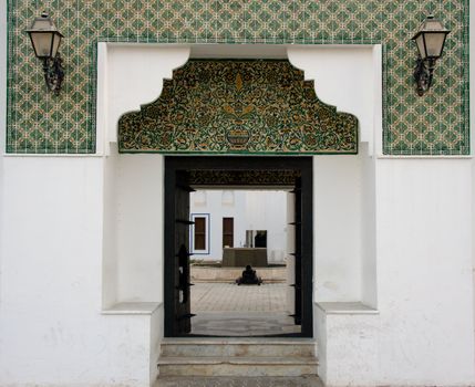 Tiled entrance to fort in Abu Dhabi in UAE with antique lamps