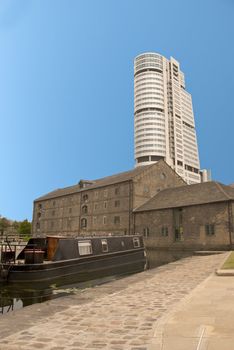 A Tower Block overlooking Canal side Buildings and a barge