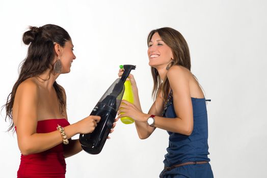 Girls fooling around with  some household equipment