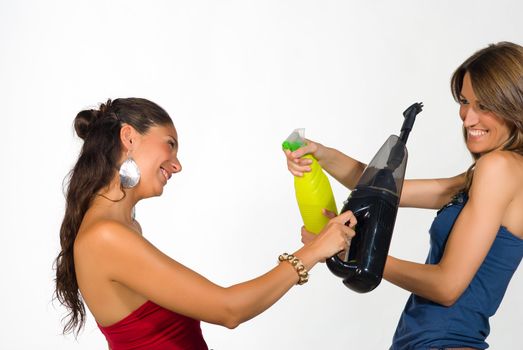 Girls fooling around with  some household equipment