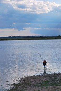 Angler in solitude on creek