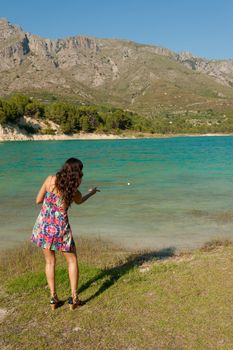 Throwing stones into an idyllic mountain lake