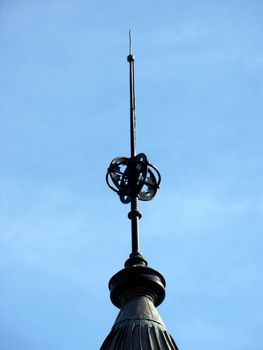 closeup portrait of spire on old building in blue sky