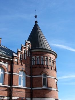 portrait of old building with tower in blue sky