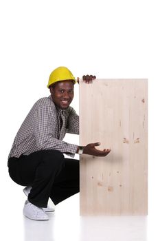 Young african american carpenter holding wooden plank on white background 