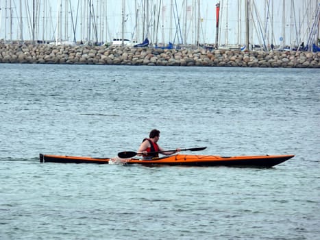 portrait of man kayaking in ocean