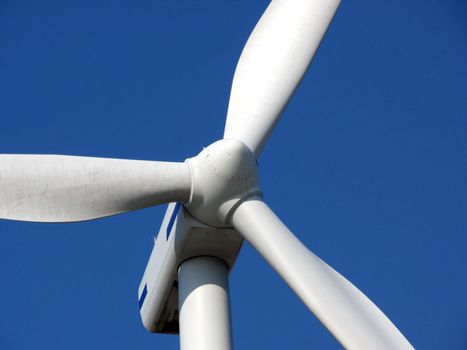 close-up portrait of wind turbine in blue sky